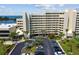 Exterior of multi-story condo complex overlooking the bay with parking and landscaping at 6009 Sea Ranch Dr # 107E, Hudson, FL 34667
