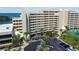 Exterior of multi-story condo complex overlooking the bay with parking and landscaping at 6009 Sea Ranch Dr # 107E, Hudson, FL 34667