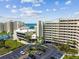 Exterior of multi-story condo complex overlooking the bay with parking and landscaping at 6009 Sea Ranch Dr # 107E, Hudson, FL 34667