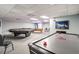 Bright, spacious game room featuring a pool table, ping pong table, air hockey, and comfortable seating at 6009 Sea Ranch Dr # 107E, Hudson, FL 34667