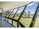 Hallway with floor-to-ceiling windows overlooking lush landscaping, providing natural light and scenic views at 6009 Sea Ranch Dr # 107E, Hudson, FL 34667