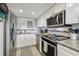 Well-lit kitchen featuring stainless steel appliances and white cabinetry, creating a modern aesthetic at 6009 Sea Ranch Dr # 107E, Hudson, FL 34667