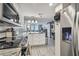 Bright kitchen featuring stainless appliances, white cabinets, and an open view to the living area at 6009 Sea Ranch Dr # 107E, Hudson, FL 34667