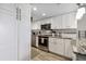 Updated kitchen featuring white cabinets and stainless steel appliances offering a modern touch at 6009 Sea Ranch Dr # 107E, Hudson, FL 34667