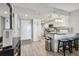 Modern kitchen with white cabinets, stainless steel appliances, and a breakfast bar with seating at 6009 Sea Ranch Dr # 107E, Hudson, FL 34667