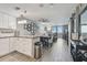Open living space with kitchen, dining, and living room, seamlessly blending together with tile floors at 6009 Sea Ranch Dr # 107E, Hudson, FL 34667