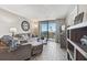 Cozy living room with balcony access offering stunning ocean views and natural light at 6009 Sea Ranch Dr # 107E, Hudson, FL 34667
