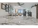 Open-concept living and dining area with a wall of framed pictures and sliding doors to the balcony at 6009 Sea Ranch Dr # 107E, Hudson, FL 34667