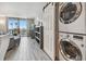 Comfortable living room with stackable washer and dryer, balcony, and ocean view at 6009 Sea Ranch Dr # 107E, Hudson, FL 34667