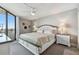 Brightly lit main bedroom with a ceiling fan and a sliding glass door to the balcony at 6009 Sea Ranch Dr # 107E, Hudson, FL 34667