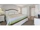 Bright main bedroom with white furniture, a ceiling fan, and an ensuite bathroom at 6009 Sea Ranch Dr # 107E, Hudson, FL 34667