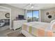 Bright main bedroom with access to the balcony, a flat screen TV and white furniture at 6009 Sea Ranch Dr # 107E, Hudson, FL 34667