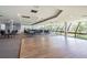 Large meeting room with hardwood flooring, tables and chairs, and scenic views from large windows at 6009 Sea Ranch Dr # 107E, Hudson, FL 34667