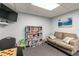 Comfortable reading nook with a sofa and bookcase perfect for relaxation at 6009 Sea Ranch Dr # 107E, Hudson, FL 34667