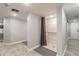 Modern shower room with marble tile, grab bars, and gray privacy curtains at 6009 Sea Ranch Dr # 107E, Hudson, FL 34667