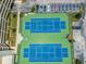 Aerial close-up of community tennis courts, showcasing well-maintained blue and green surfaces at 6009 Sea Ranch Dr # 107E, Hudson, FL 34667