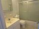 Cozy bathroom showcasing a vanity, commode, and shower with sliding glass doors at 6015 19Th N St # 301, St Petersburg, FL 33714