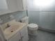 Cozy bathroom showcasing a vanity, commode, and shower with sliding glass doors at 6015 19Th N St # 301, St Petersburg, FL 33714