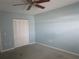A simple bedroom offering a ceiling fan, closet and a soothing, neutral wall color at 6015 19Th N St # 301, St Petersburg, FL 33714