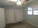 A bedroom with an abundance of closet space, a ceiling fan, and natural light at 6015 19Th N St # 301, St Petersburg, FL 33714