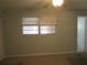 A clean bedroom featuring a window for natural light and a ceiling fan at 6015 19Th N St # 301, St Petersburg, FL 33714