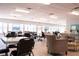 Spacious and well-lit common area with tables, chairs, and comfortable seating, perfect for socializing and activities at 6015 19Th N St # 301, St Petersburg, FL 33714