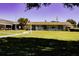 A welcoming community building surrounded by a well-manicured lawn, featuring an office and covered seating area at 6015 19Th N St # 301, St Petersburg, FL 33714