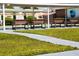 A well-maintained community space with benches, lush green grass, and a covered walkway, perfect for relaxation and socializing at 6015 19Th N St # 301, St Petersburg, FL 33714