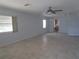 Expansive living room with neutral tile flooring, ceiling fan, and abundant natural light from multiple windows at 6015 19Th N St # 301, St Petersburg, FL 33714