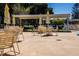 Community patio area with tables and chairs shaded by umbrellas at 6015 19Th N St # 301, St Petersburg, FL 33714
