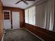 A bright sun room featuring wood paneled walls and multiple windows for natural light at 6015 19Th N St # 301, St Petersburg, FL 33714