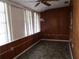 Wood-paneled sunroom with tiled floors, large windows and an overhead light fixture offers a peaceful retreat at 6015 19Th N St # 301, St Petersburg, FL 33714