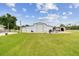View of the barn on a large lot with green grass under a blue sky at 6080 Taneytown St, North Port, FL 34291