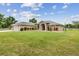 Charming ranch-style home with a lush green lawn and a well-maintained landscape, perfect for outdoor enjoyment at 6080 Taneytown St, North Port, FL 34291
