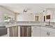 Bright kitchen features white cabinets and stainless steel appliances and stone countertops at 6080 Taneytown St, North Port, FL 34291