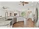 Bright open kitchen with stainless steel appliances and fixtures, stone counter tops, and wood floors at 6080 Taneytown St, North Port, FL 34291