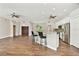 Bright open-concept living area featuring hardwood floors, a breakfast bar, and modern finishes, perfect for entertaining guests at 6080 Taneytown St, North Port, FL 34291