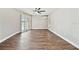 Spacious living room with wood floors, sliding glass door to patio, and neutral paint at 6080 Taneytown St, North Port, FL 34291