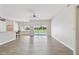 Bright open-concept living space with hardwood floors and sliding glass doors leading to outdoor pool area at 6080 Taneytown St, North Port, FL 34291