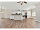 Open concept living and kitchen area featuring wood floors, island with seating, and white cabinets at 6080 Taneytown St, North Port, FL 34291