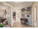 Tiled hallway decorated with pictures and a sewing machine at 616 Highview S Cir, Brandon, FL 33510
