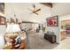 Open-concept living room with carpet, ceiling fan, sofas, and doorway to kitchen at 616 Highview S Cir, Brandon, FL 33510