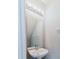 Powder room featuring modern lighting, a mirror, and stylish sink at 6260 Olivedale Dr, Riverview, FL 33578