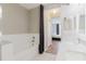 View of a bathroom featuring a tub, shower with curtain and a look at the vanity and bedroom at 6260 Olivedale Dr, Riverview, FL 33578
