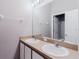 Bathroom featuring dual sinks, a large mirror, and modern lighting and a view into the shower at 6260 Olivedale Dr, Riverview, FL 33578