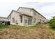 Exterior backyard of a townhouse with small patio area and grass at 6260 Olivedale Dr, Riverview, FL 33578
