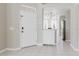 Bright and airy foyer featuring tile flooring and a modern lighting fixture at 6260 Olivedale Dr, Riverview, FL 33578