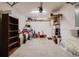 Cluttered garage space showing various stored items and shelving at 6260 Olivedale Dr, Riverview, FL 33578