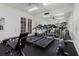 Bright gym with treadmills, mirrored wall, and natural light from large windows at 6260 Olivedale Dr, Riverview, FL 33578