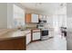 Bright kitchen with stainless steel appliances, white cabinetry, and ample counter space at 6260 Olivedale Dr, Riverview, FL 33578